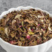 A bowl of Davidson's Organic Valentine White Tea with rose petals and leaves.