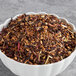 A bowl of Davidson's Organic Seasons Herbal loose leaf tea with dried fruit and spices.