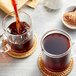 A glass mug filled with Davidson's Organic Red Vanilla Herbal tea.