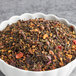 A bowl of Davidson's Organic Christmas Loose Leaf Tea with dried fruit and nuts.