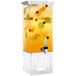 A Rosseto clear acrylic beverage dispenser with yellow liquid and fruit inside.