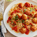 A plate of spaghetti with Cutting Vedge Plant-Based Artichoke Italian-Style Meatballs and sauce.