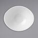 A Dudson Organic White china bowl with a white rim on a gray surface.