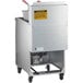 An Avantco natural gas floor fryer with a stainless steel container on wheels.