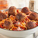 A bowl of spaghetti and Gardein plant-based vegan meatballs with sauce.