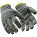 A pair of RefrigiWear midweight glove liners with yellow lining and a yellow stripe.
