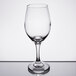 A close-up of a Libbey Perception wine glass on a reflective surface.