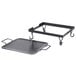 An American Metalcraft wrought iron griddle with a black metal handle on a stand.
