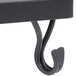 A black wrought iron griddle stand with a hook.