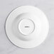 An Acopa Cordelia bright white porcelain bowl with an embossed circle on the rim.