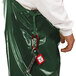 A person wearing green Tingley Iron Eagle overalls with patch pockets and a red lock attached.