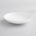 An Acopa Cordelia bright white porcelain bowl with an embossed design on a white background.