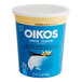 A white container of Oikos Nonfat Greek Yogurt with a yellow flower on it.