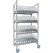 A white Cambro Camshelving® Premium rack with clear plastic dome cradle shelves holding plastic containers.