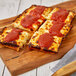 A rectangular Rich's gluten-free Detroit-style pizza with sauce on top.