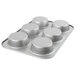 A close-up of a Chicago Metallic silver mini cake/jumbo muffin pan with six holes.