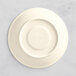 A Oneida warm white porcelain saucer with a white rim.