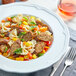 A bowl of pasta with Field Roast Italian Garlic and Fennel Sausage links and vegetables.