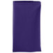 A folded purple Intedge cloth napkin.