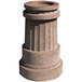 A stone pillar with a round bowl on top and a hole in the center.