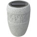 A gray stone urn with a black lid.
