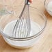 A whisk being whisked into a bowl of Instant Non-Fat Milk
