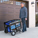A man pushing a DuroMax portable generator on a cart.