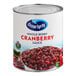 A white #10 can of Ocean Spray Whole Berry Cranberry Sauce with a bowl of cranberries.