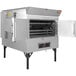 A Southern Pride gas rotisserie smoker with open doors.
