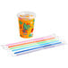 A Choice Dinosaur print plastic cup with lid and straw next to colorful plastic straws.