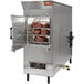 A Southern Pride MLR-850 gas rotisserie smoker with meat inside.