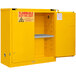 A yellow metal Durham safety cabinet with a shelf.