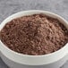 A bowl of Pillsbury Handkut Devil's Food Cake Donut Mix, a brown powder.
