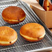 Pillsbury Yeast-Raised Donuts on a metal rack.