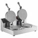A Nemco double grid waffle cone maker on a metal stand with two round waffles.