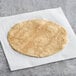 A Mr. Tortilla multigrain tortilla on a white surface.
