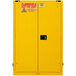 A yellow Durham Mfg safety cabinet with a warning sign and a key.