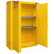 A yellow metal Durham Mfg safety cabinet with shelves and self-closing doors.