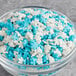 A bowl of blue and white snowflake sprinkles.