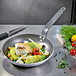 A de Buyer Choc Resto Induction fry pan with vegetables and fish cooking in it.