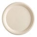 A close-up of an EcoChoice natural bagasse plate with a round shape and thin rim.