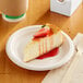 A slice of cheesecake on an EcoChoice natural bagasse paper plate.