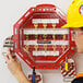 A man in a hard hat using an Accuform Look N Stop group lock box.