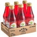 A group of Rose's Grenadine Syrup bottles in a cardboard box.