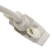 A close-up of a white Tor Rey serial cable plug with two white wires.