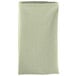 A folded seafoam green Intedge cloth napkin.