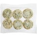 A plastic bag containing round white Veggies Made Great Egg White and Spinach Frittatas with green and white toppings.