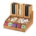 A Cal-Mil Bamboo condiment organizer on a counter holding a variety of tea bags.