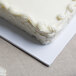 A close up of a white Enjay half sheet cake board.