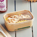 A chicken and rice take-out meal in an EcoChoice compostable PLA lid.